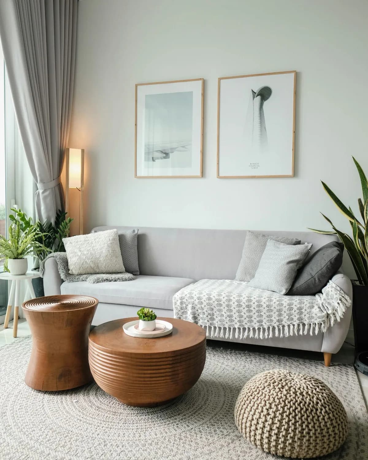 Modern living room with a gray sofa and wood coffee tables
